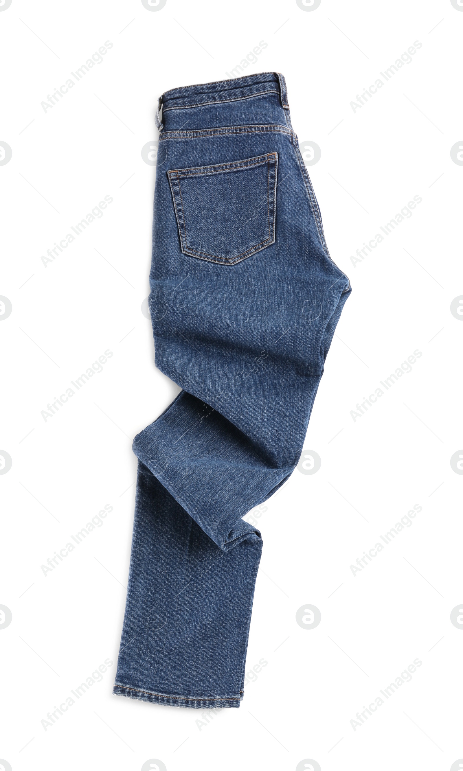 Photo of Rumpled dark blue jeans isolated on white, top view. Stylish clothes