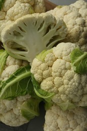 Closeup of fresh whole and cut cauliflowers, top view
