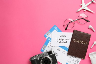 Photo of Flat lay composition with passport and tickets on pink background. Space for text