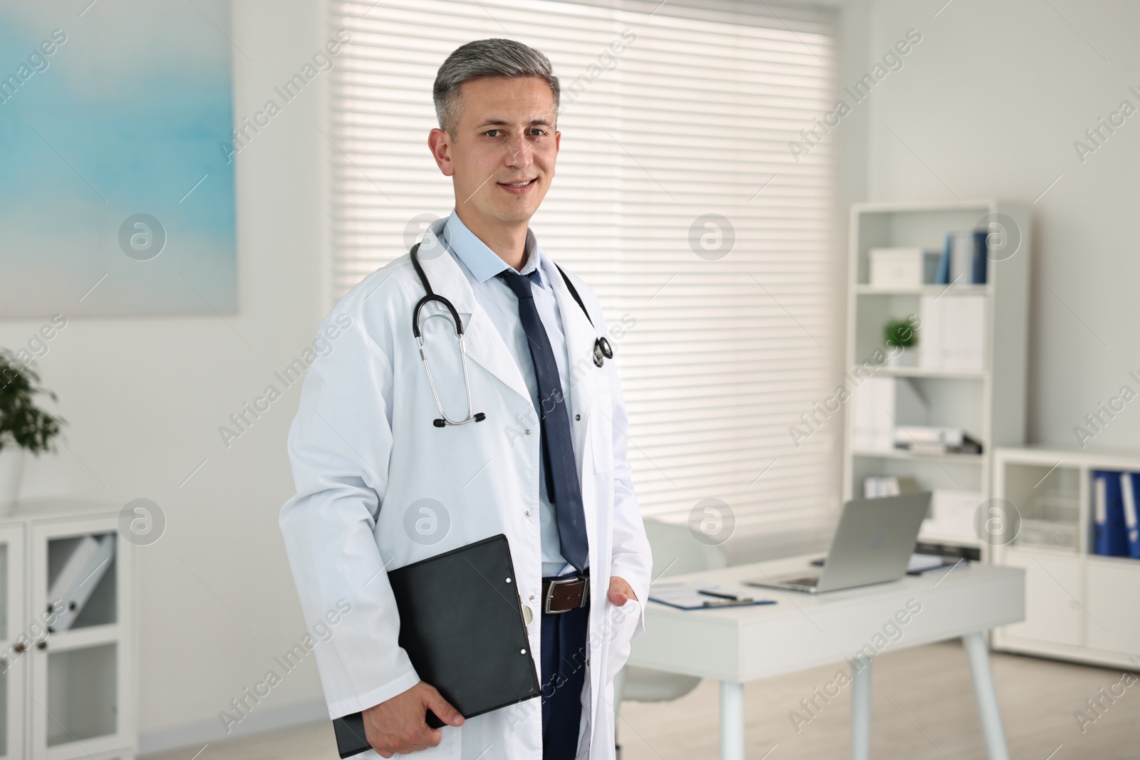 Photo of Doctor with stethoscope and clipboard in clinic, space for text