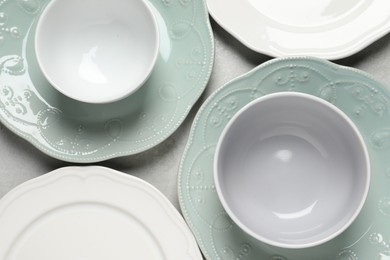 Photo of Beautiful ceramic dishware on light grey table, flat lay