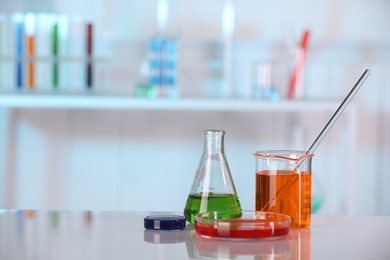 Laboratory analysis. Different glassware with liquids on white table indoors. Space for text