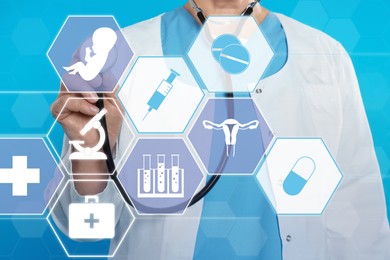 Doctor pointing at different virtual icons on blue background. Reproductive medicine concept