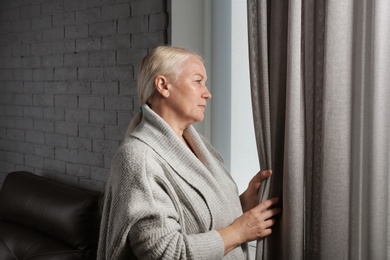 Mature woman suffering from depression at home