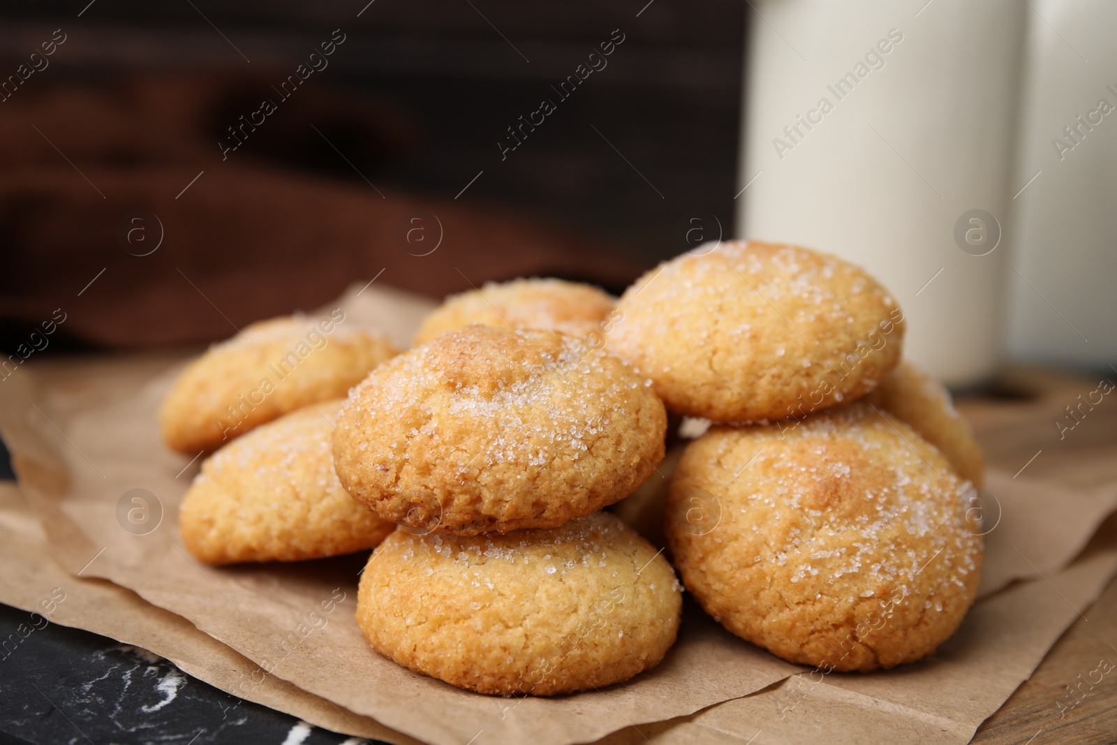 Photo of Tasty sweet sugar cookies and milk on table, closeup