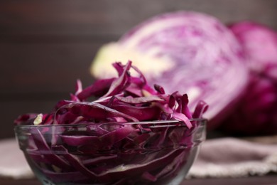 Photo of Fresh chopped red cabbage in bowl on table, closeup