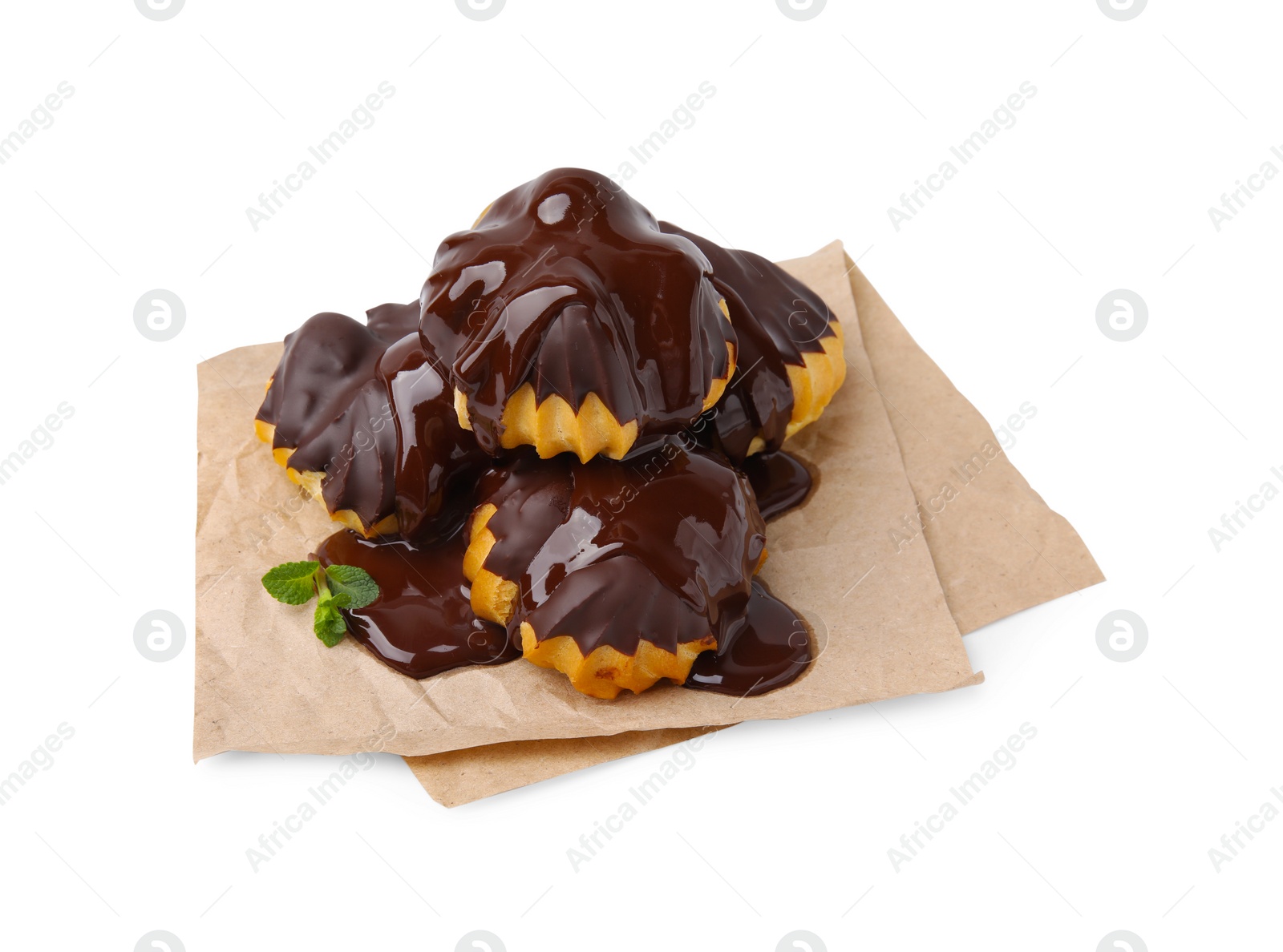 Photo of Delicious profiteroles with chocolate spread and mint isolated on white