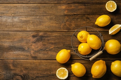 Flat lay composition with lemons on wooden background