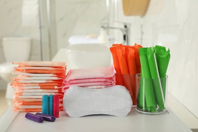Photo of Different feminine hygiene products on counter in bathroom