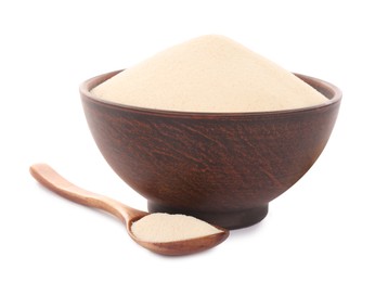 Semolina in bowl and wooden spoon on white background