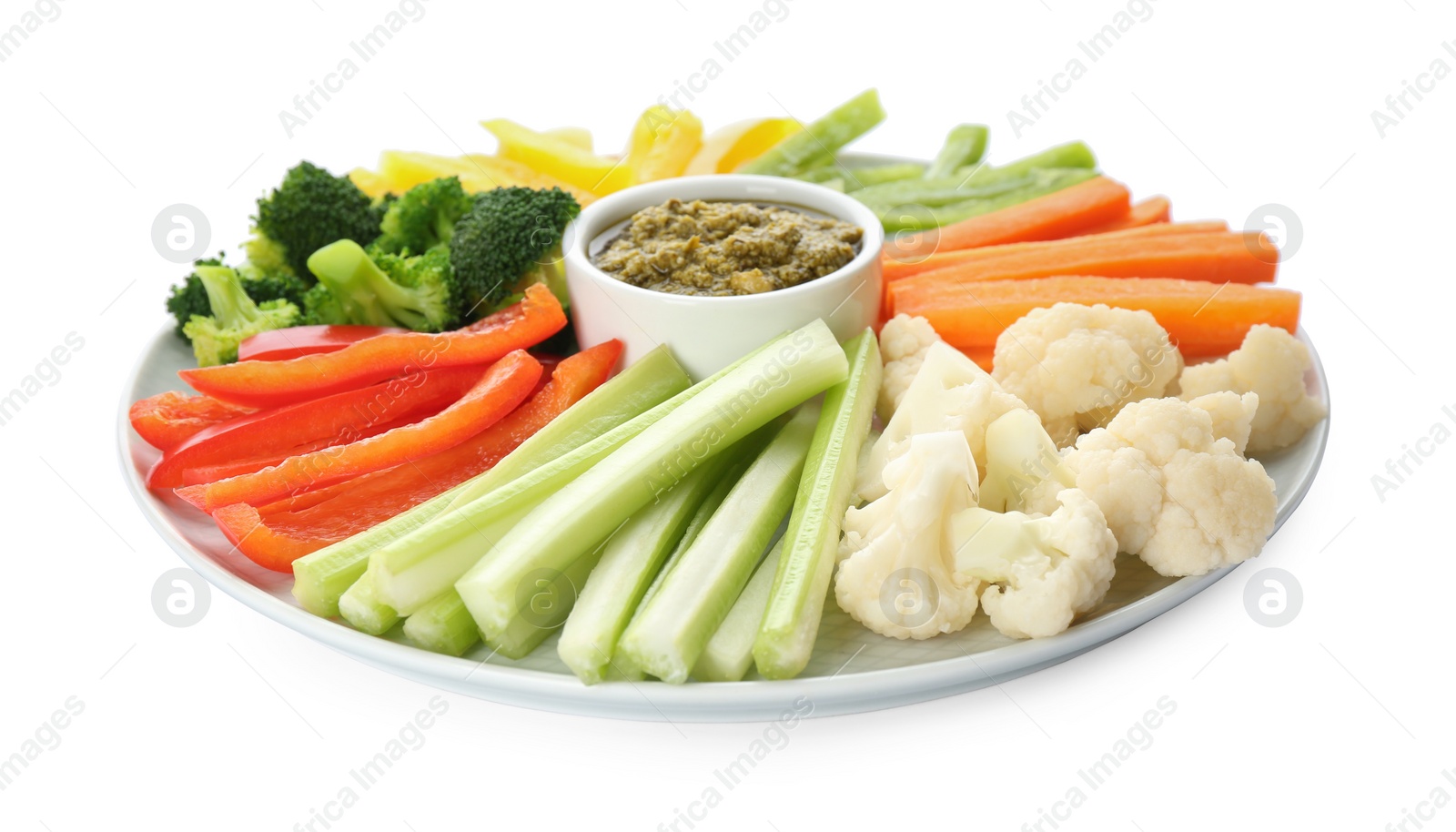 Photo of Plate with celery sticks, other vegetables and dip sauce isolated on white