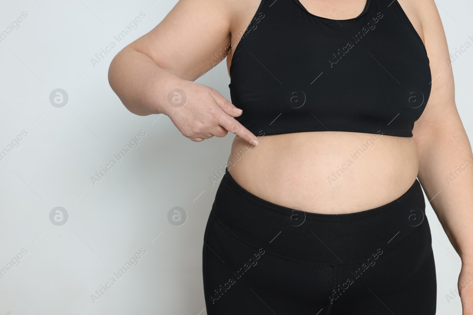 Photo of Obese woman on white background, closeup with space for text. Weight loss surgery