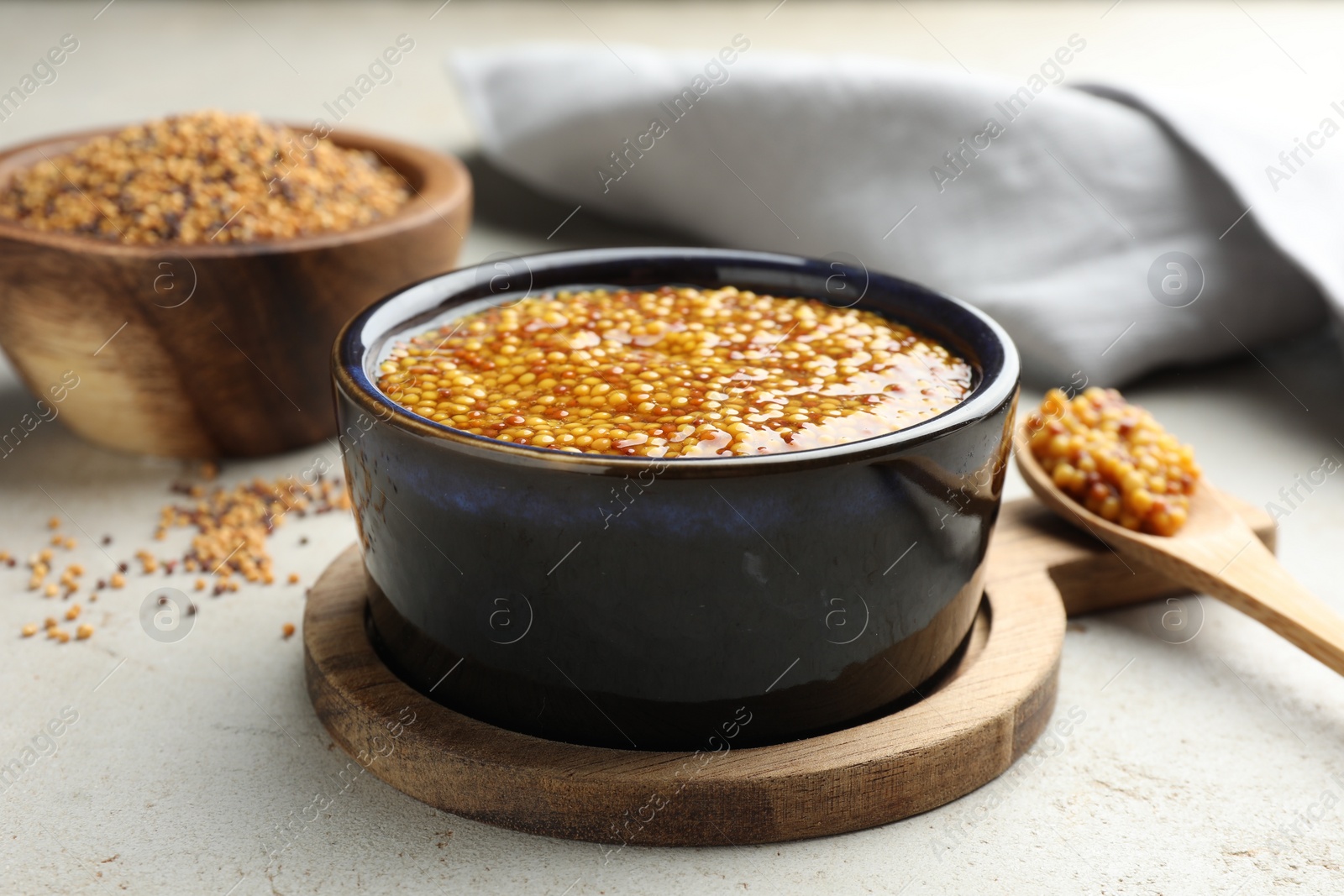 Photo of Whole grain mustard in bowl on light table