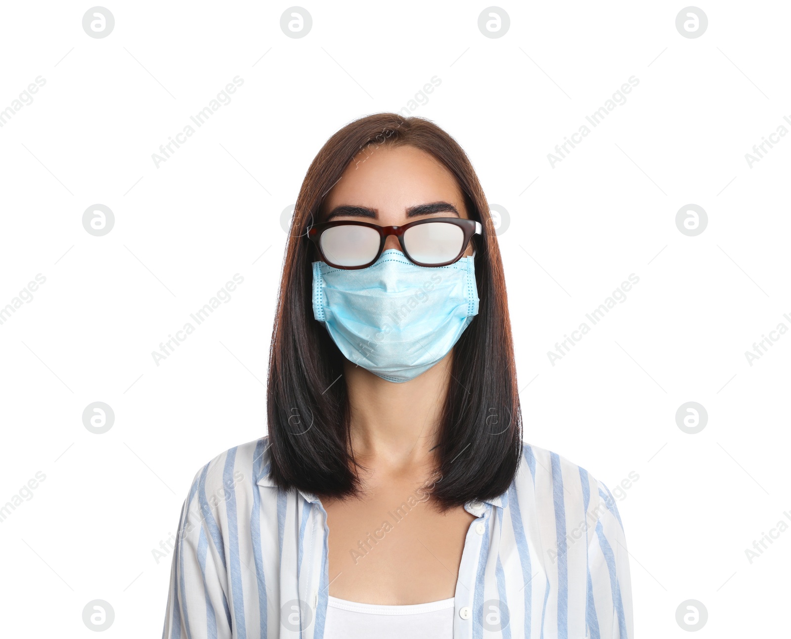 Photo of Young woman with foggy glasses caused by wearing disposable mask on white background. Protective measure during coronavirus pandemic