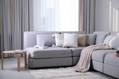 Living room interior with large grey sofa