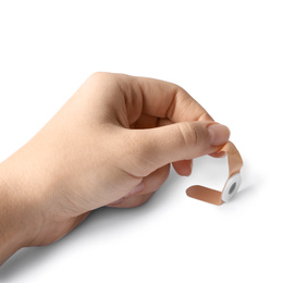 Photo of Woman putting sticking plaster on white background. First aid item