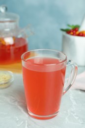 Photo of Immunity boosting drink on light grey marble table