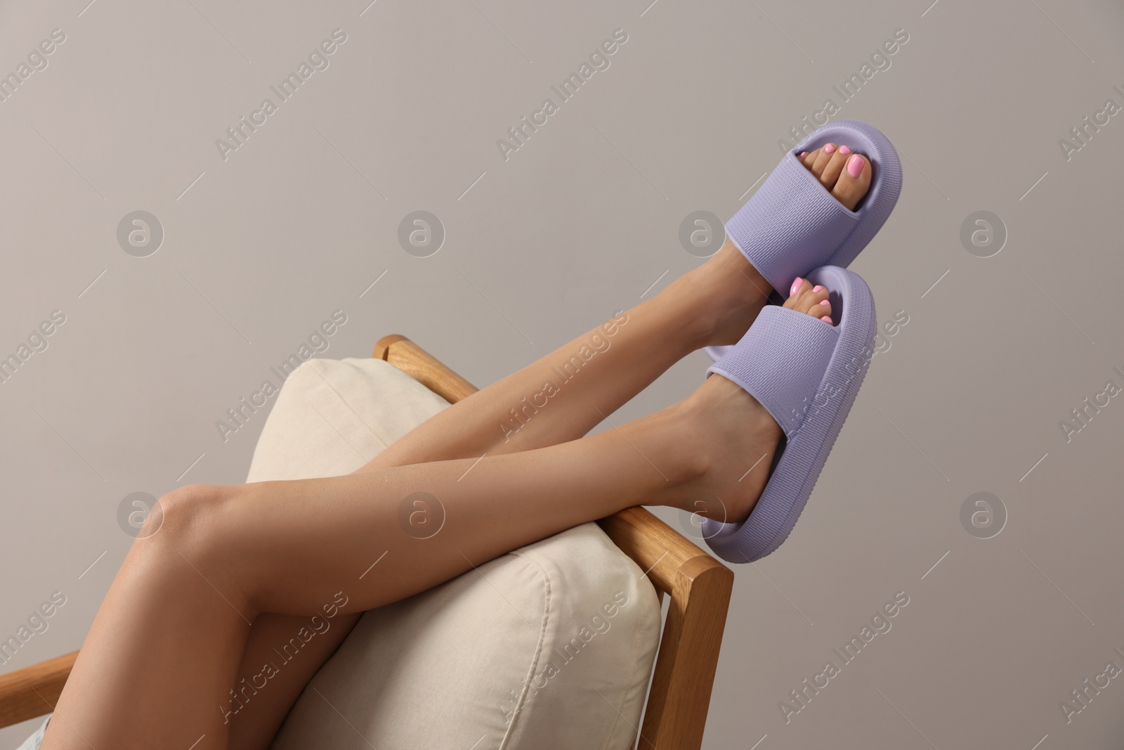 Photo of Woman wearing comfortable rubber slippers indoors, closeup