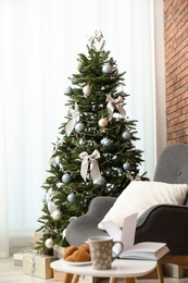 Stylish living room interior with decorated Christmas tree