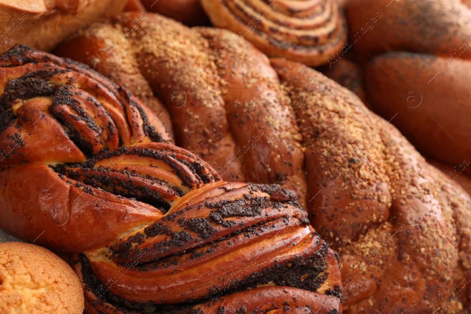 Photo of Different tasty freshly baked pastries as background, closeup
