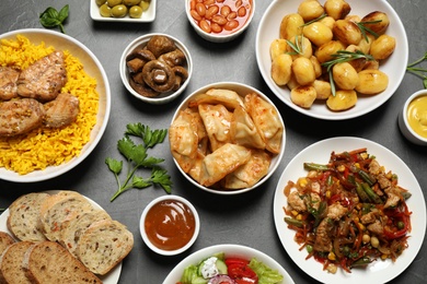 Buffet service. Many different dishes on grey table, flat lay