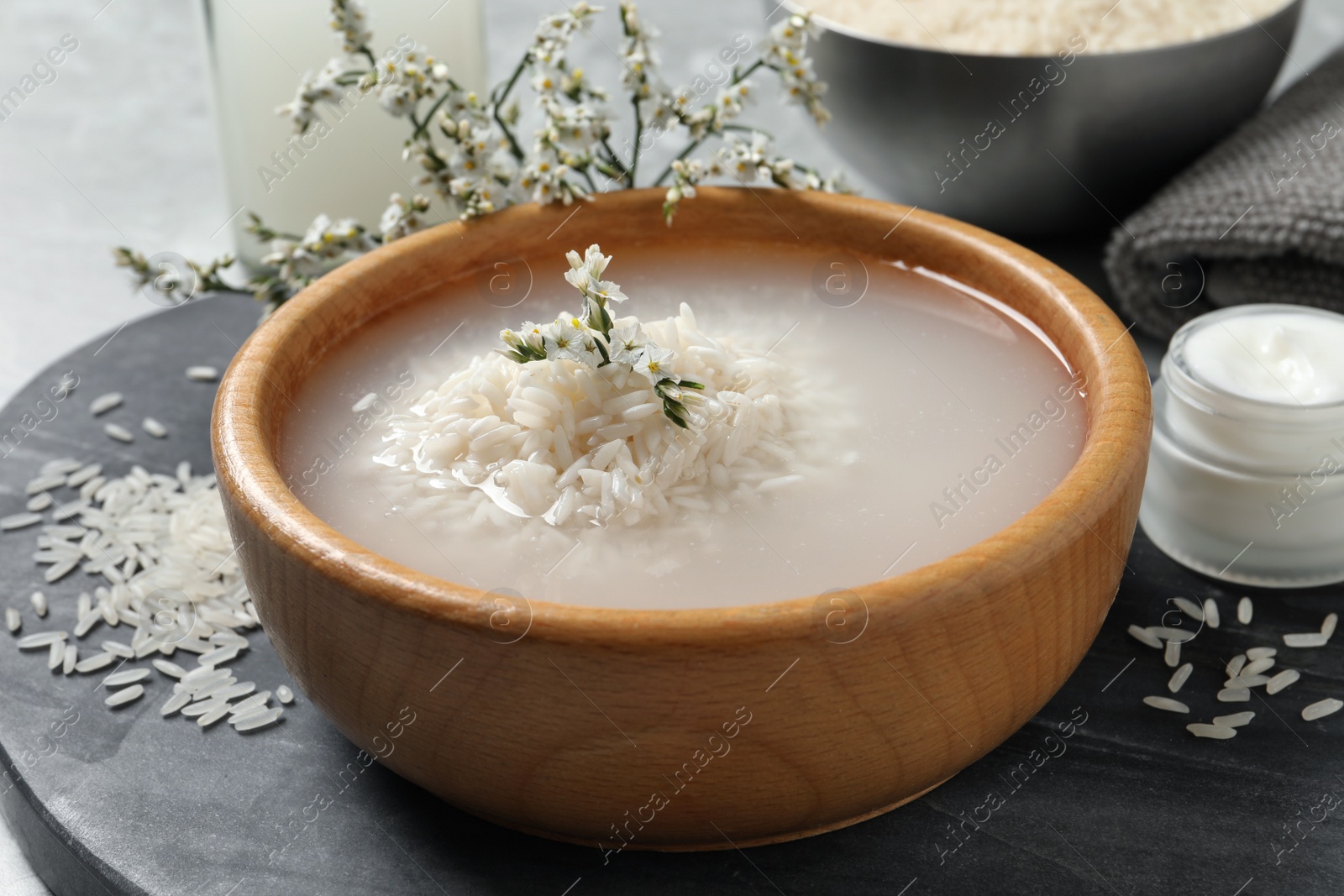 Photo of Bowl with soaked rice on table, closeup