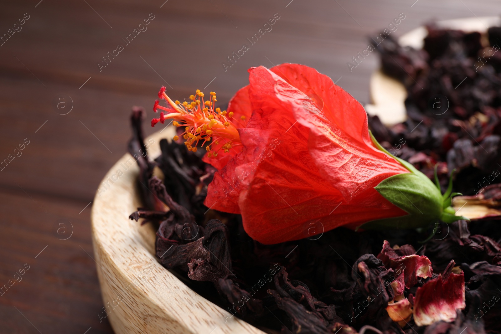 Photo of Dry hibiscus tea and beautiful flower on tray, closeup