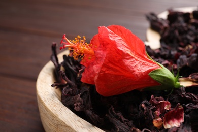 Photo of Dry hibiscus tea and beautiful flower on tray, closeup
