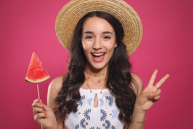 Photo of Beautiful young woman with watermelon on pink background