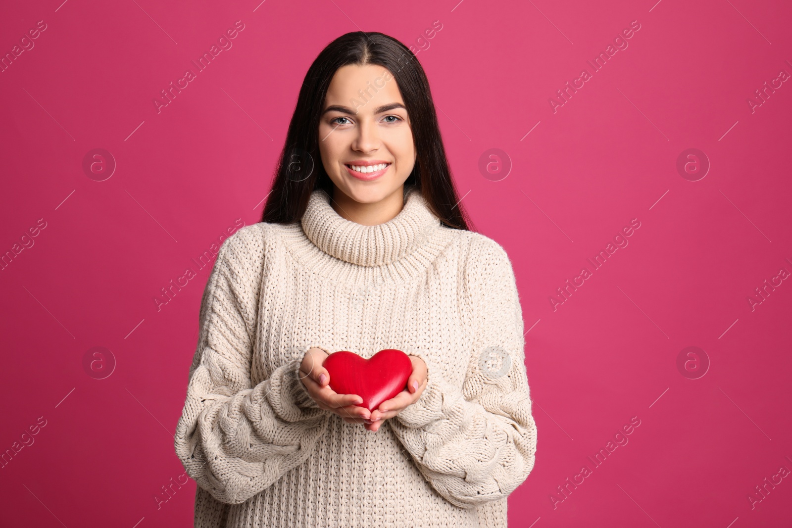 Photo of Portrait of young woman with decorative heart on color background