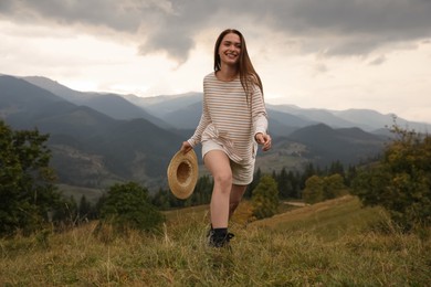Young woman with stylish hat enjoying her time in mountains