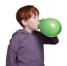 Boy inflating green balloon on white background
