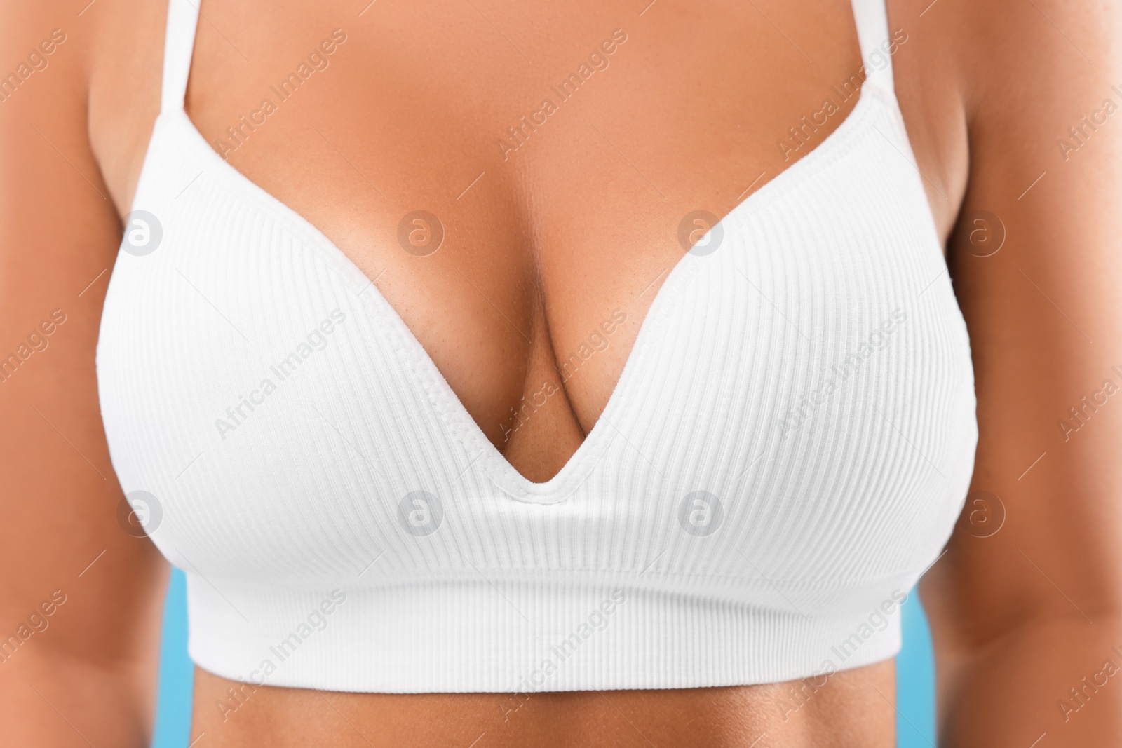 Photo of Woman with beautiful breast in white bra, closeup