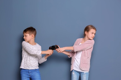 Photo of Brother arguing with sister on color background