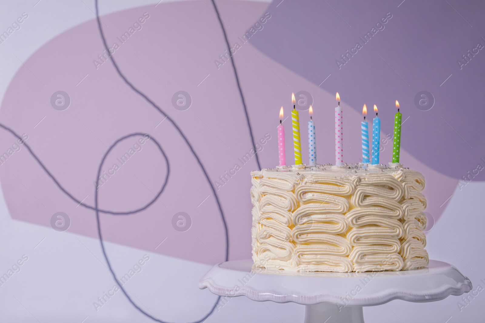 Photo of Delicious cake with cream burning candles on color background. Space for text