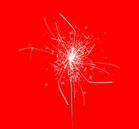 Image of Beautiful sparkler burning on red background. Party decor