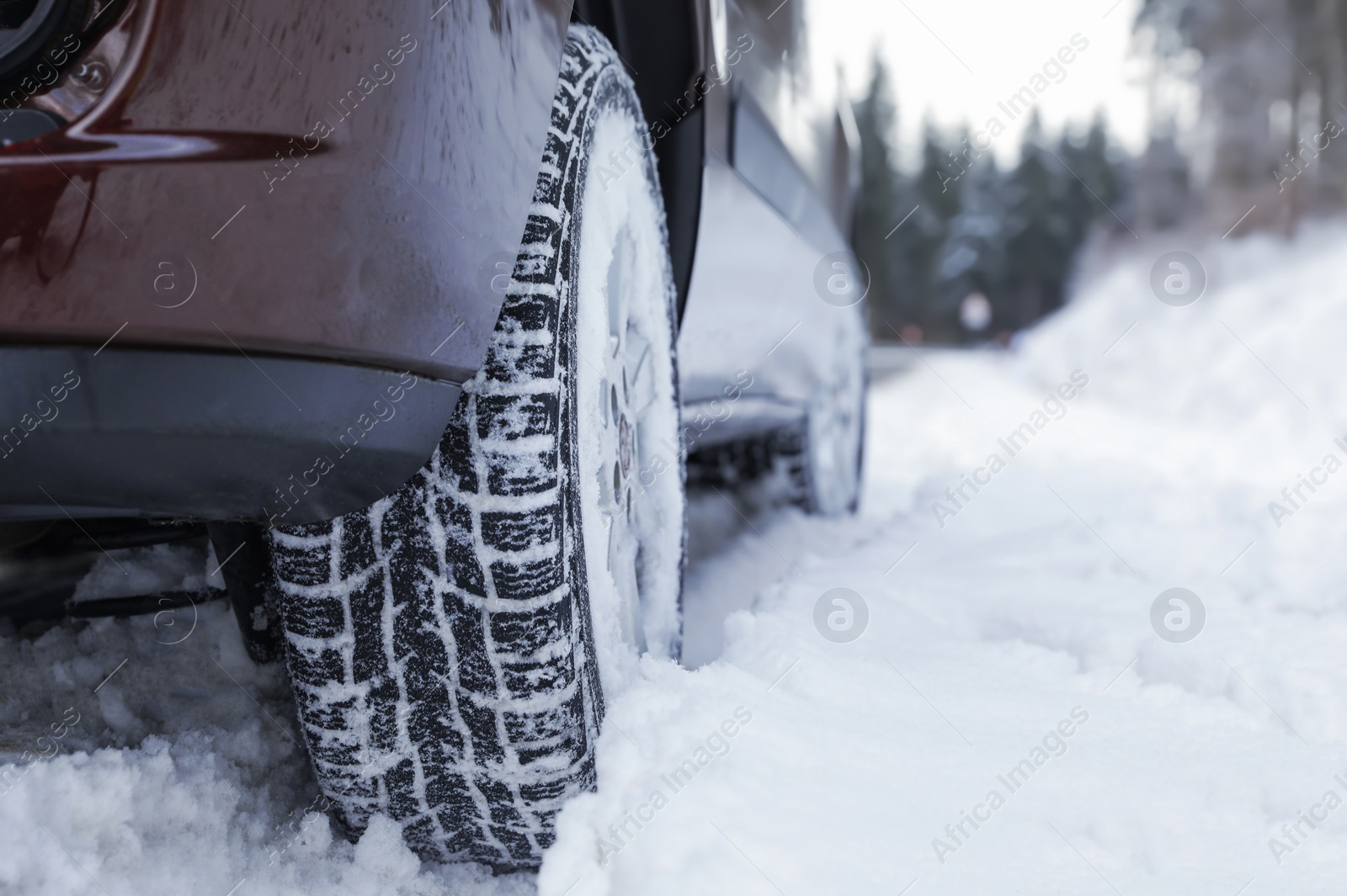 Photo of Closeup view of car in snow near road. Space for text