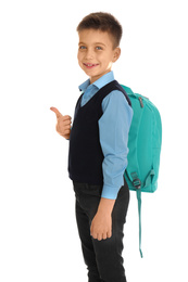 Photo of Little boy in school uniform with backpack on white background