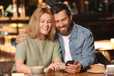 Photo of Romantic date. Lovely couple spending time together in cafe
