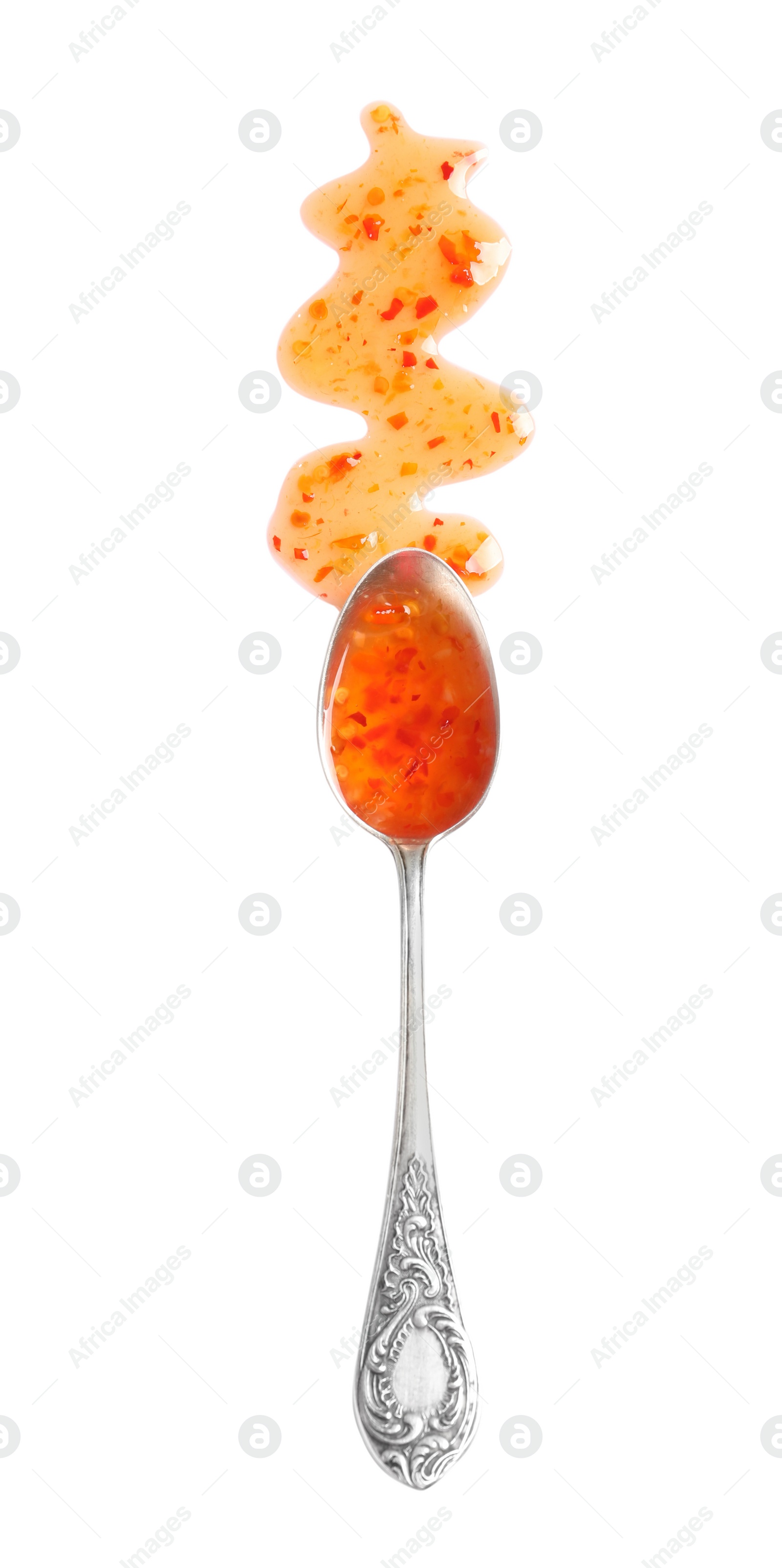 Photo of Delicious sweet chili sauce and spoon on white background, top view