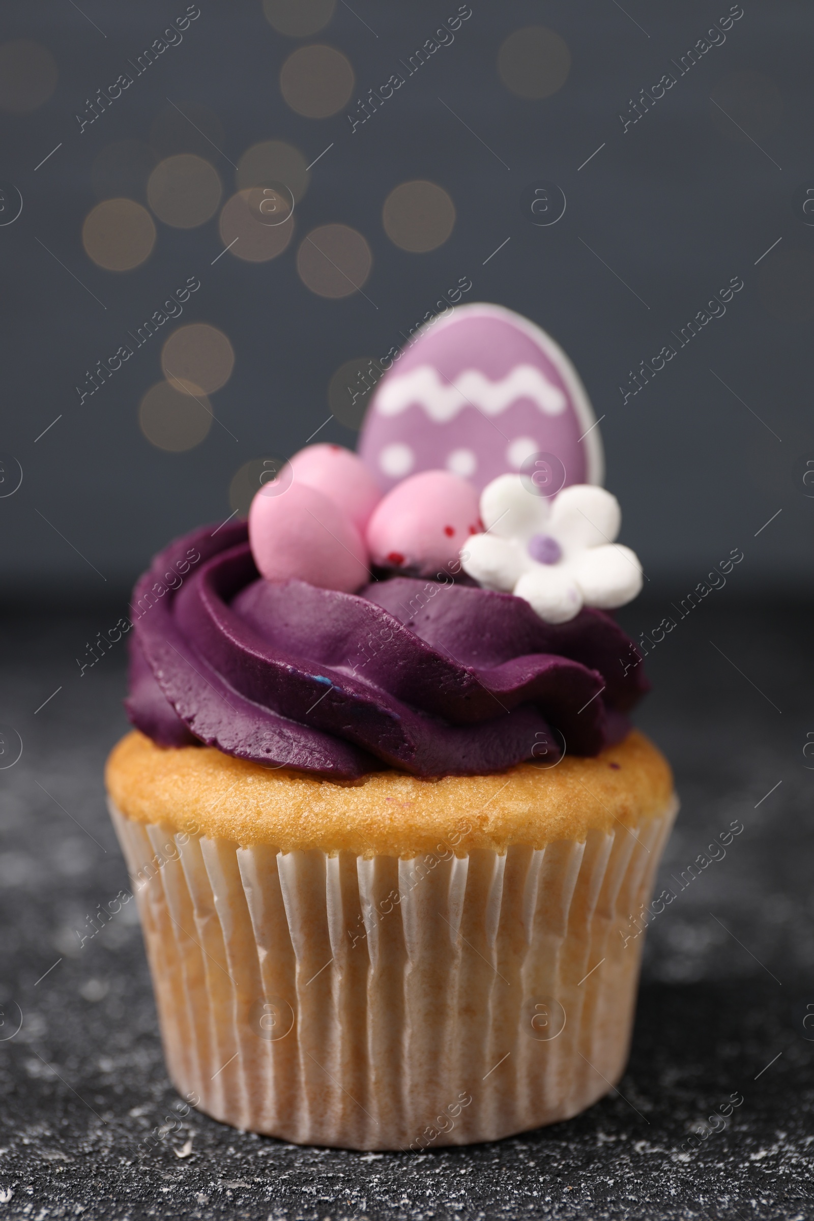 Photo of Tasty decorated Easter cupcake on grey table, closeup