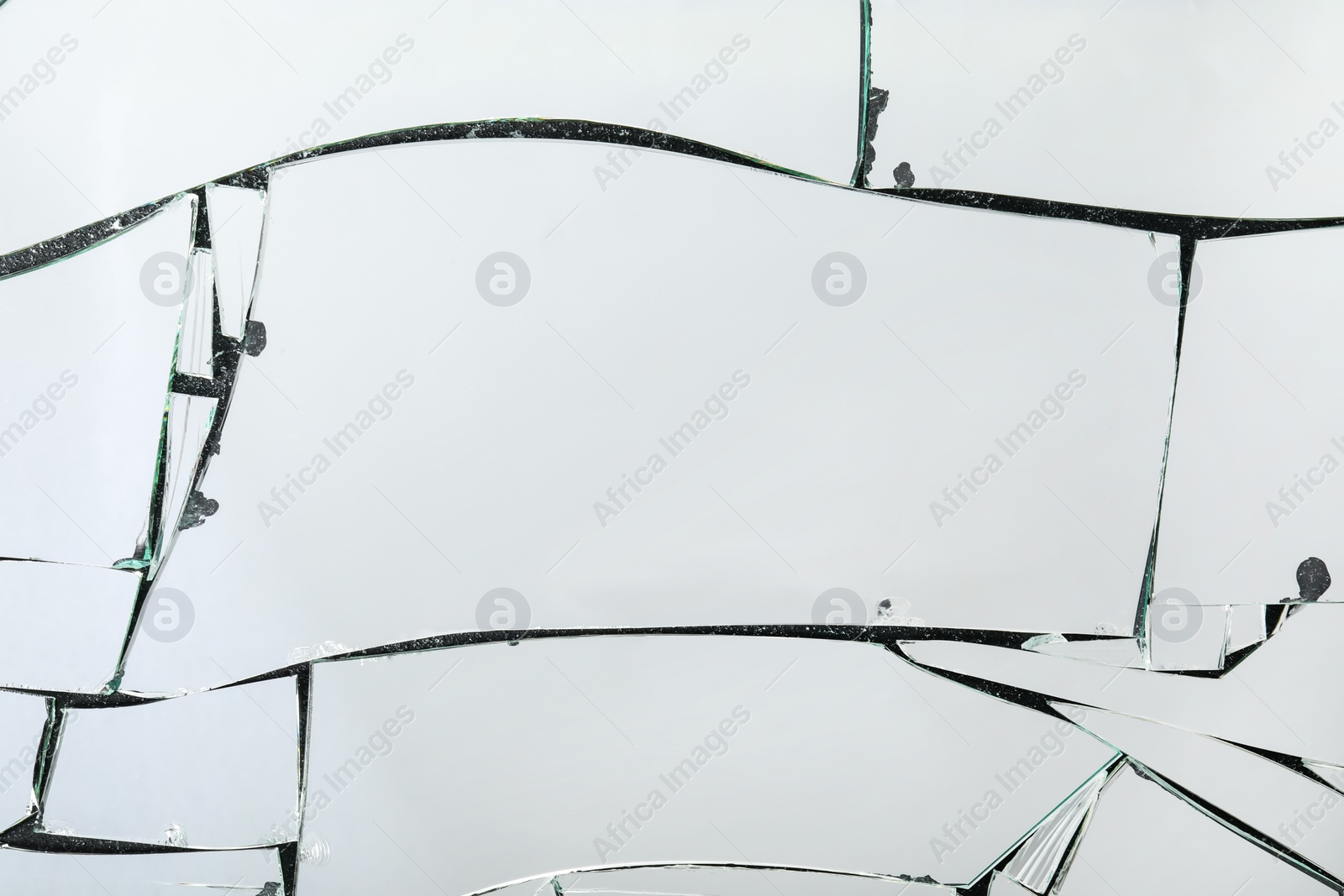 Photo of Shards of broken mirror on dark background, top view