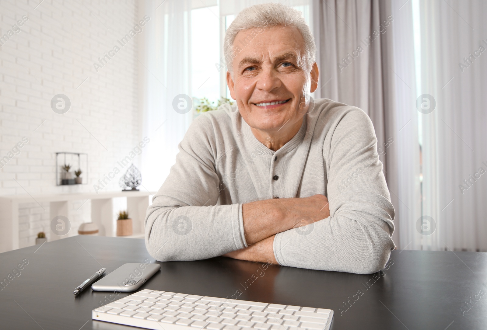 Photo of Mature man using video chat at home, view from web camera
