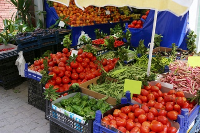 Photo of Plastic crates with delicious vegetables at market