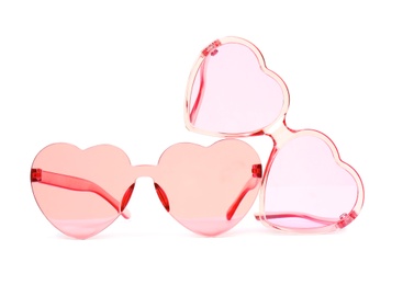 Different stylish heart shaped glasses on white background