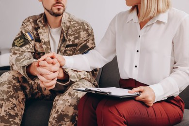 Psychologist supporting military officer in office, closeup