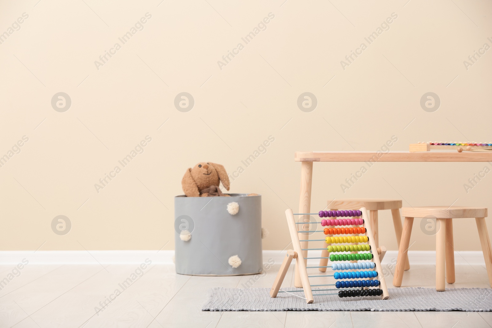 Photo of Stylish child's room interior with toys and new furniture, space for text