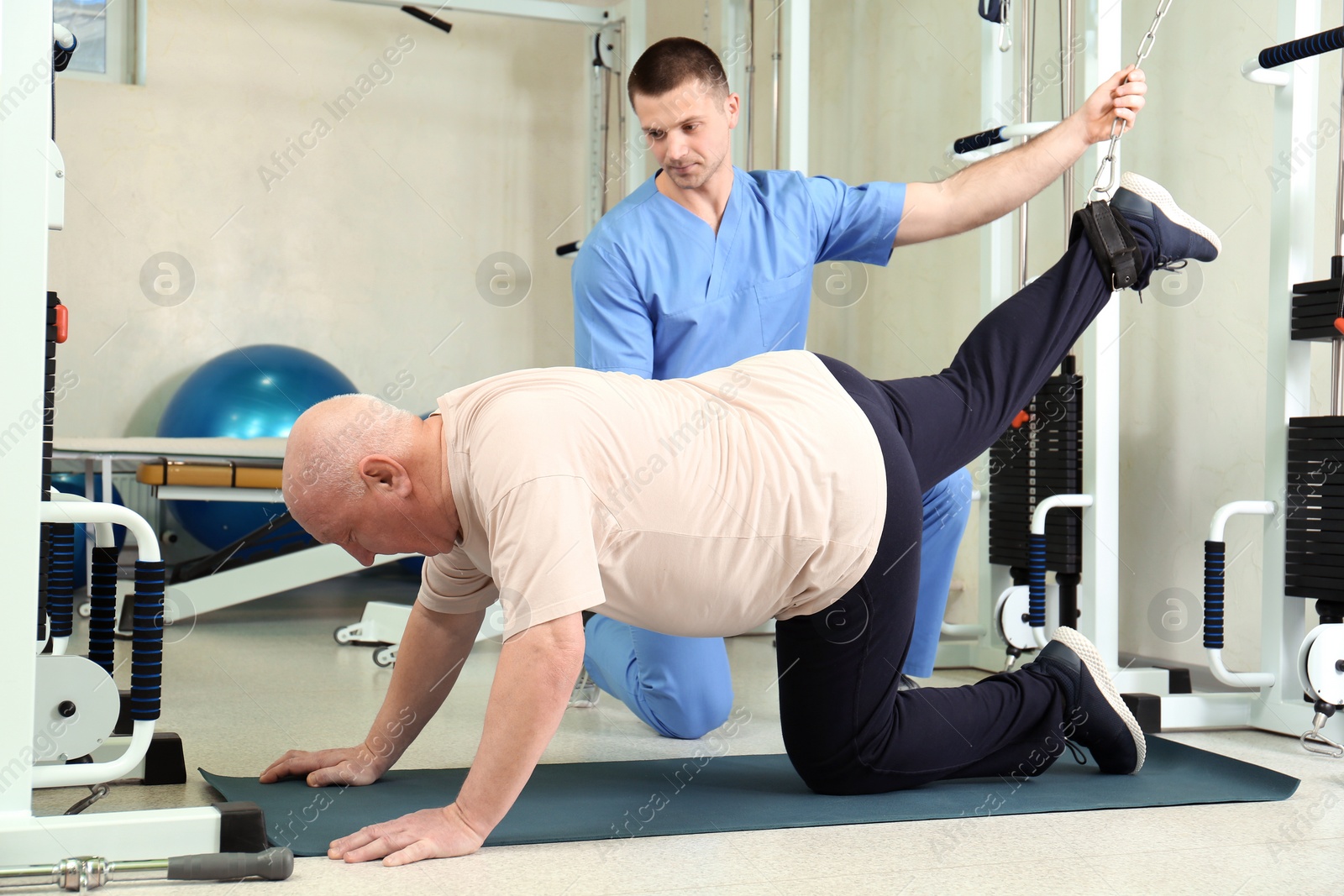 Photo of Patient exercising under physiotherapist supervision in rehabilitation center