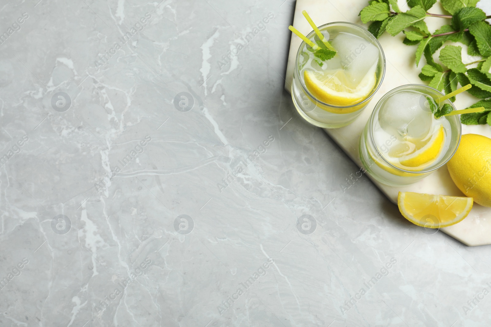 Photo of Cocktail with vodka and lemon on marble table, flat lay. Space for text