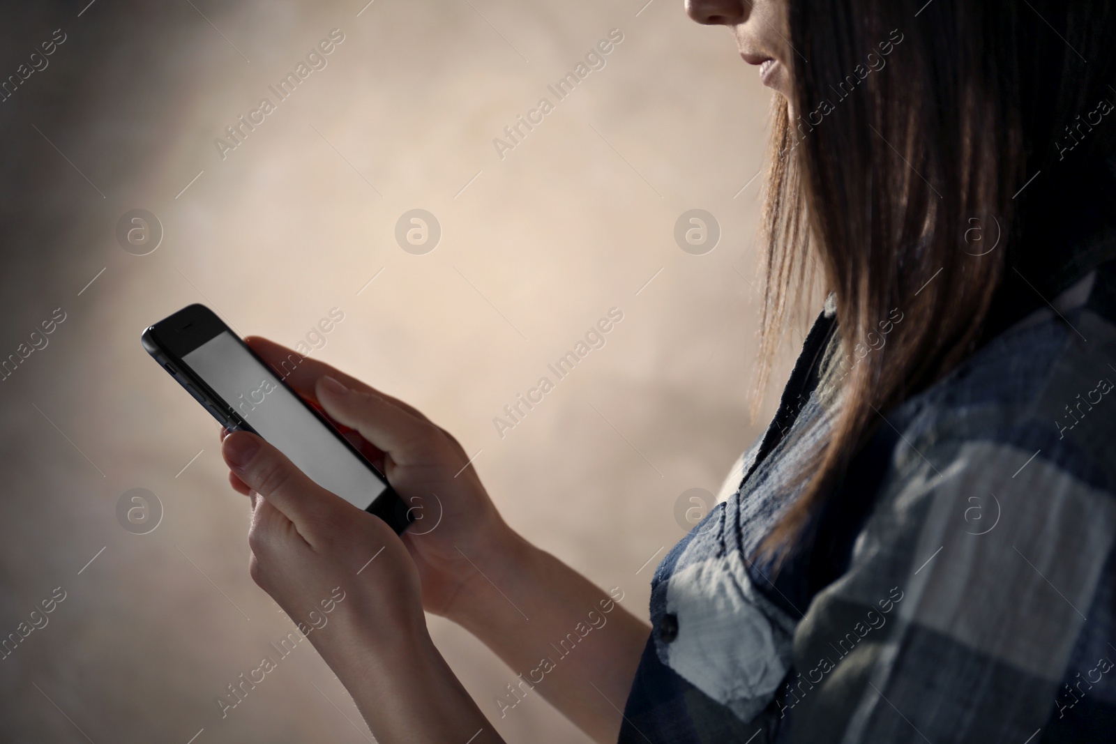 Photo of Woman using smartphone in dark room, closeup with space for text. Loneliness concept